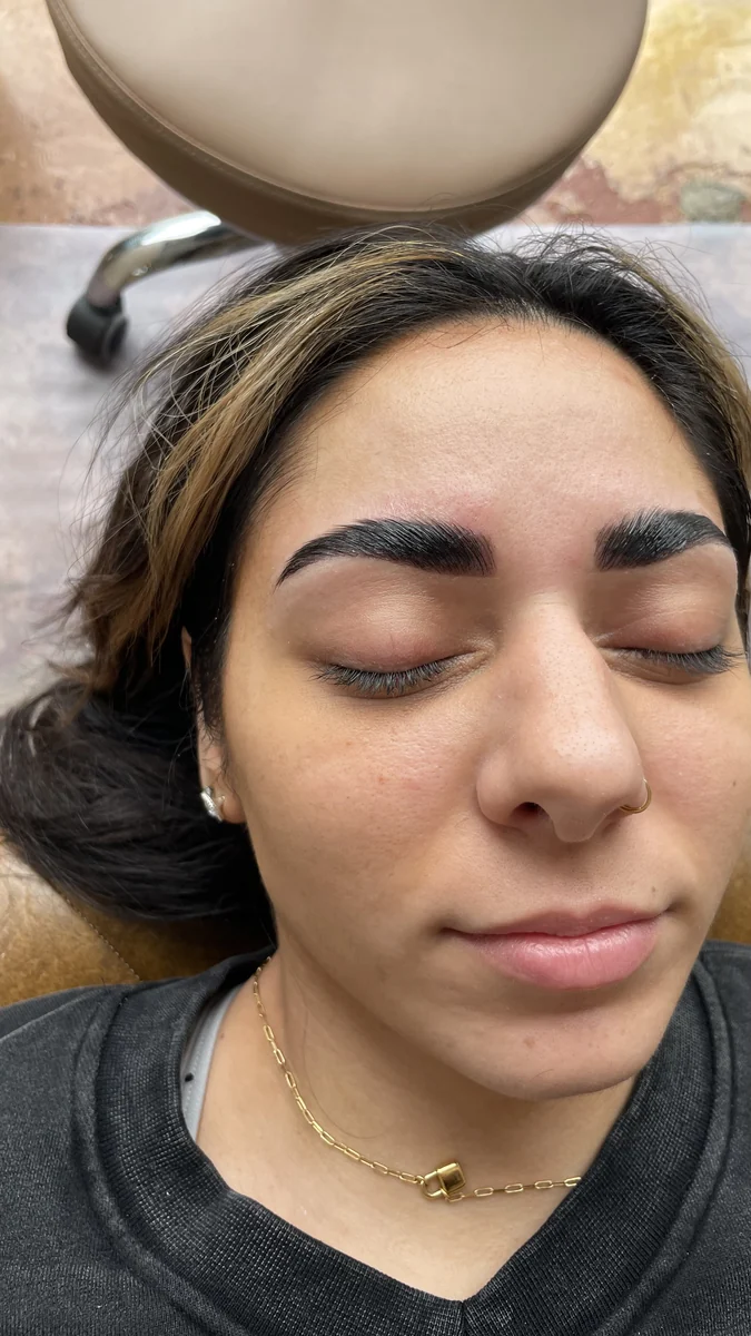 Client resting with eyes closed, showing full, brushed-up brows