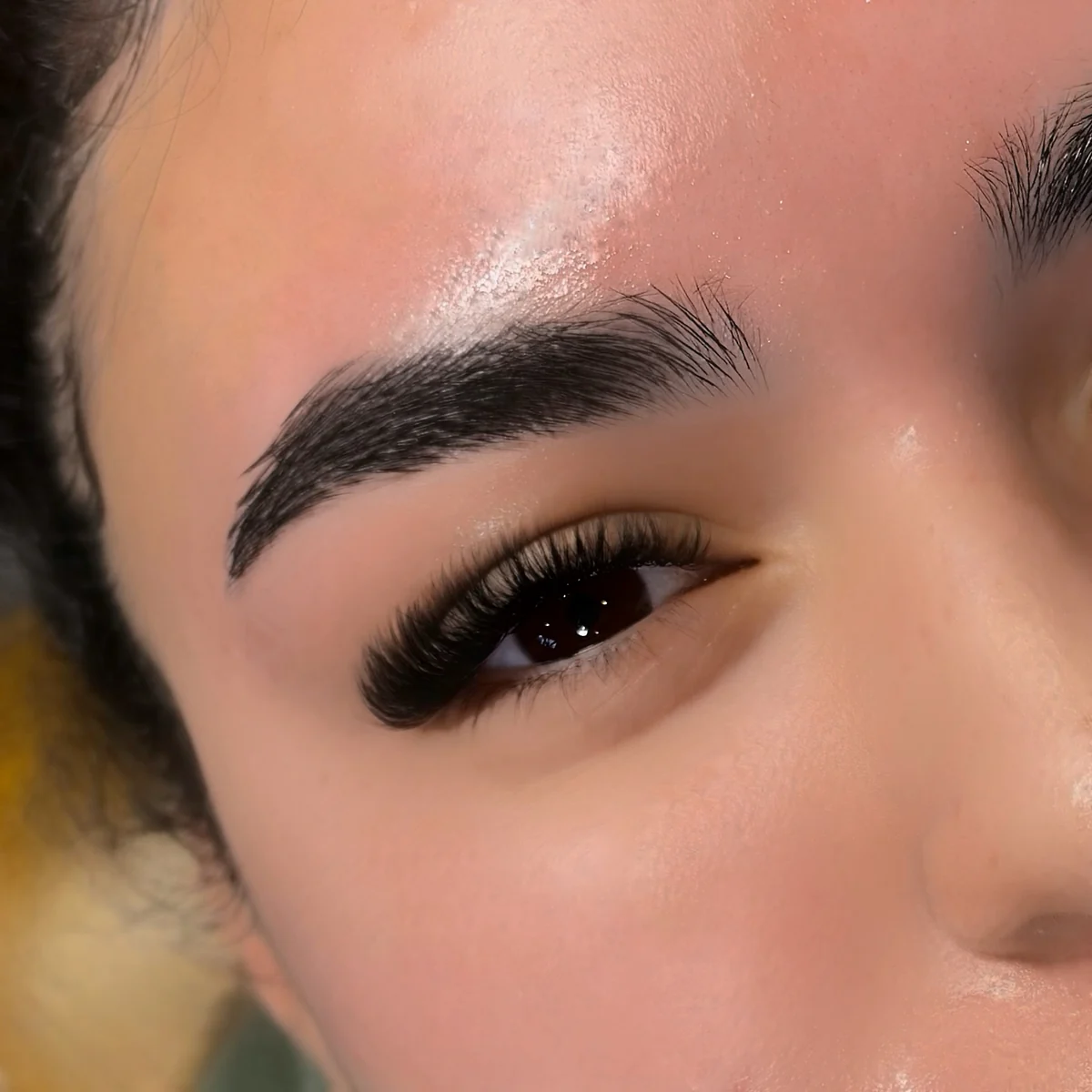 Close-up of dense, curled lashes and a defined brow