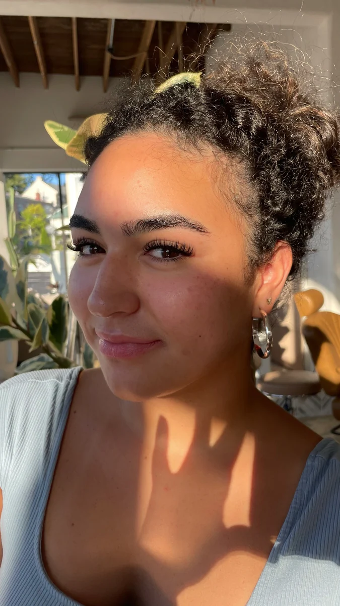 Sunlit client portrait showing full, curled lashes